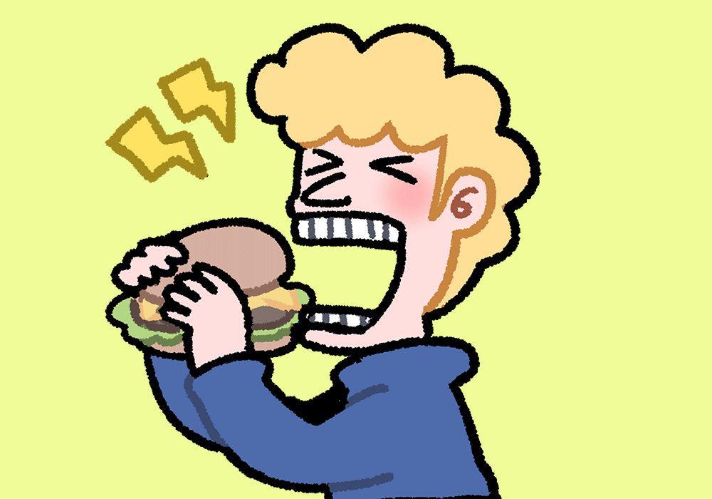 ハンバーガーをほおばる男の子